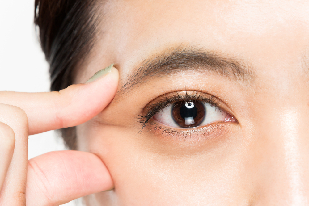 Get dry eye treatment in New York at I Love LASIK, model showing her dry eye symptoms.